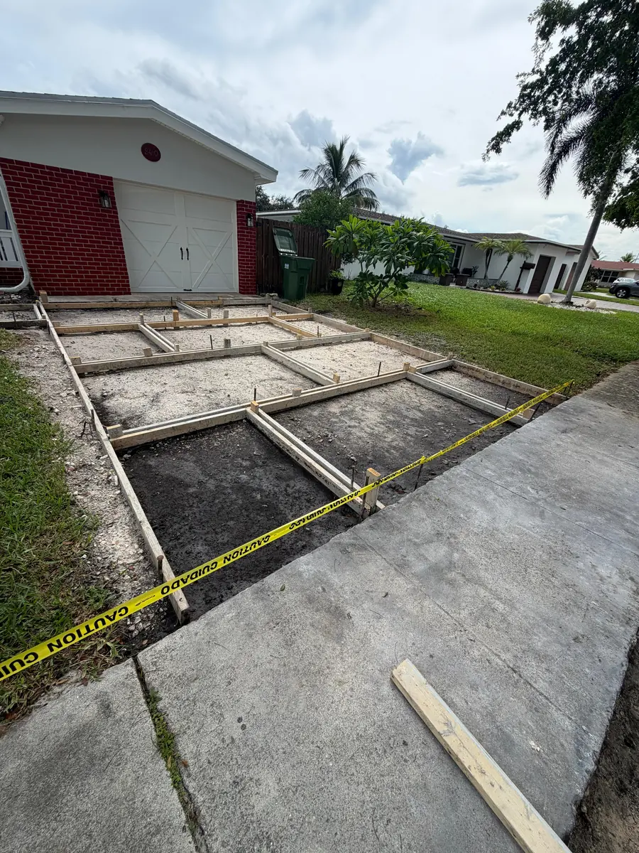 Driveway: forms to finished concrete with turf strips - before