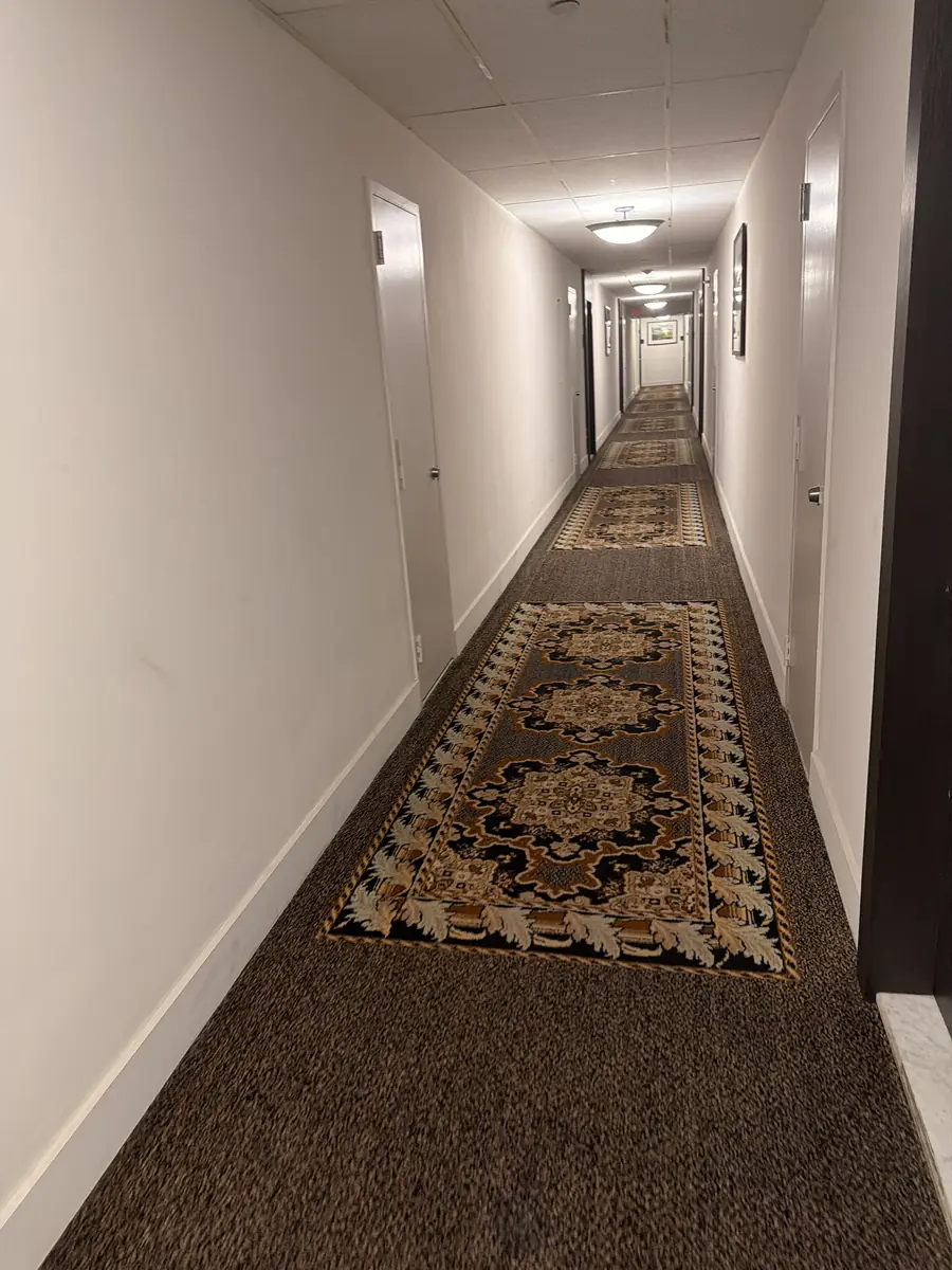Condo hallway: old carpet to glossy large-format porcelain tile - before